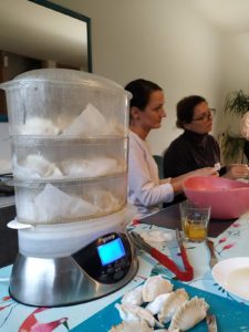 steaming the dumplings in electrical steamer and the discussion in the background